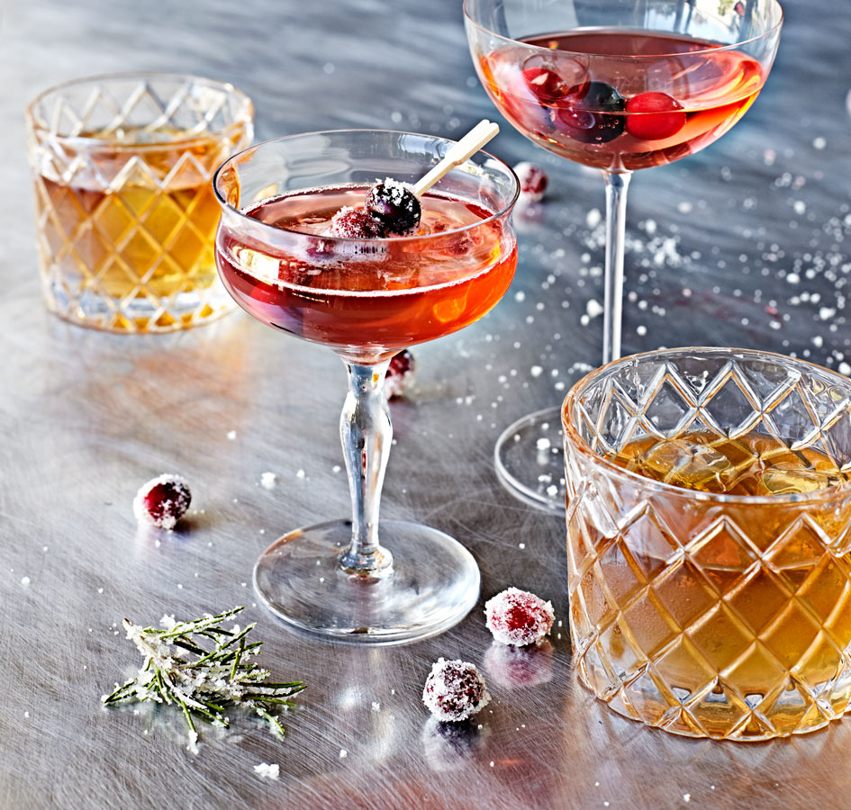 Holiday cocktails with sugared rosemary and cranberries