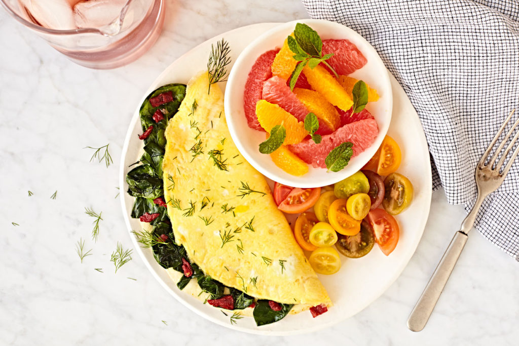 Nutritious healthy omelet with tomatoes and citrus