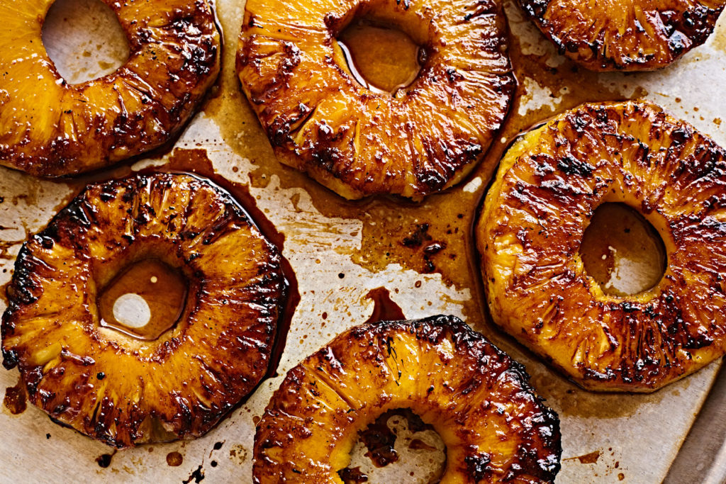 Grilled pineapple rings caramelized with piña colada glaze