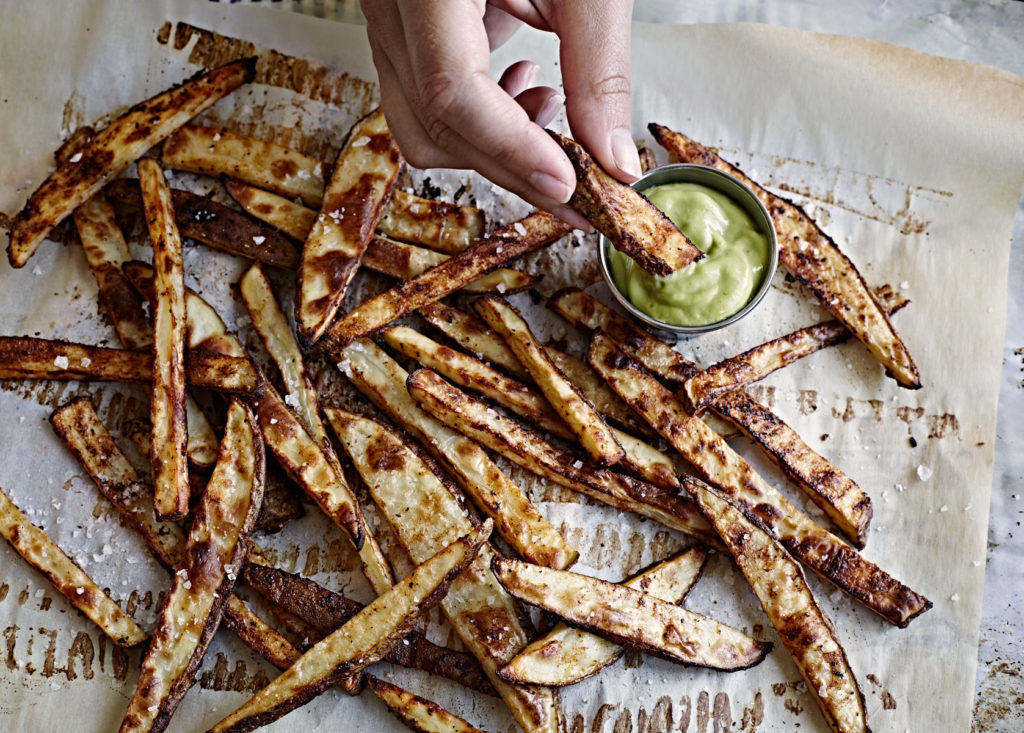 Hand dipping oven baked fries in avocado aoli.