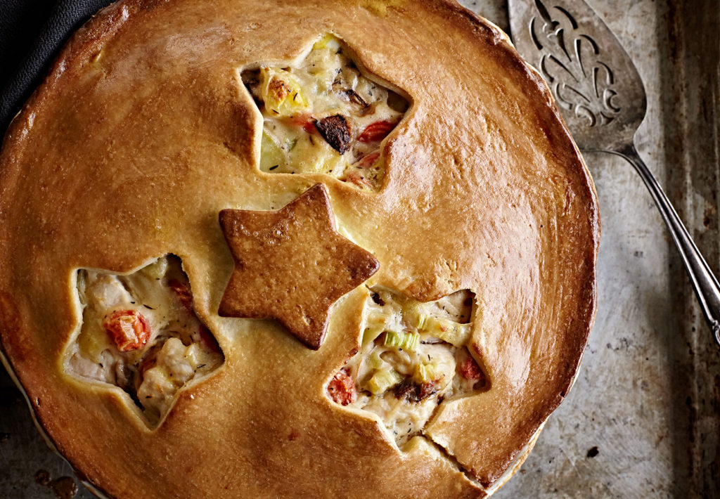 Gluten-free chicken pot pie with flaky crust and star cut-outs.