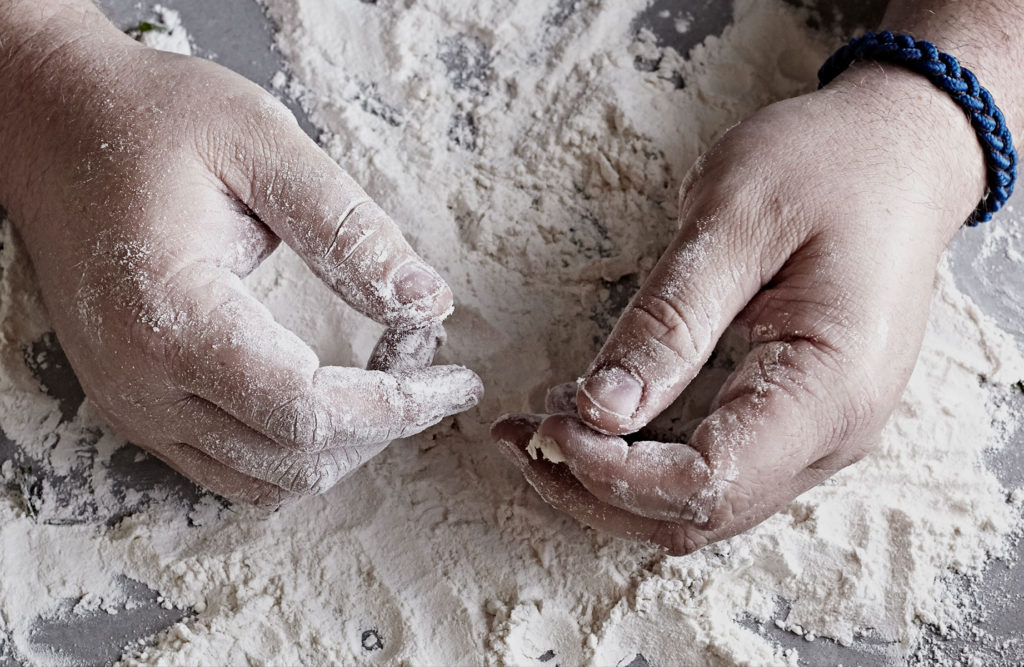 Man's hand in flour.