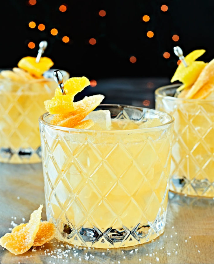 Candied Ginger Bourbon Smash on glasses with twinkling lights.
