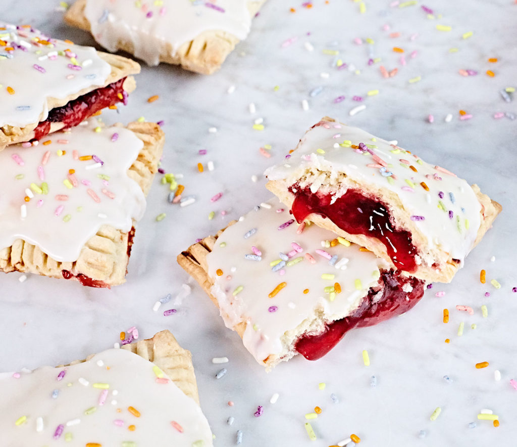 Gluten-free strawberry pop tarts with icing and sprinkles.