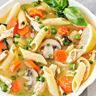 One pot lemon chicken soup with pasta in a bowl.